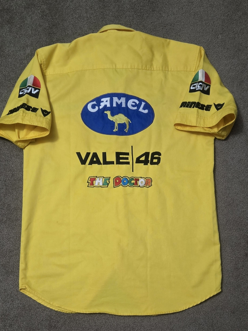 Vintage Valentino Rossi Yamaha Yellow Racing Logo Shirt with Red Sun Emblem.
